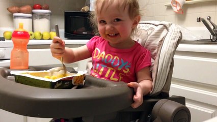 Baby eats macaroni and cheese