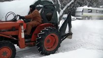 Plowing with the Homemade tractor snow plow mount