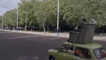 Mr Bean goes driving around London in his mini