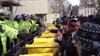Protesters clash with riot police at the Syrian Embassy in