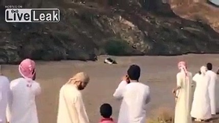 Vehicle with Arabs on top of it Drifting in Flood