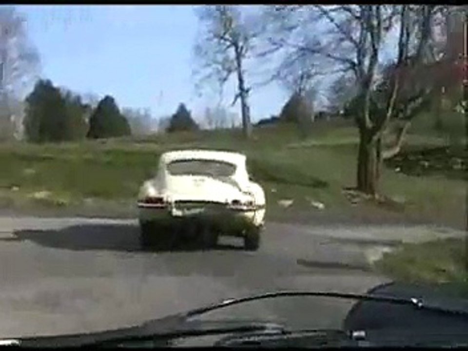 1966 Jaguar E-Type (XKE) followed by 1974 Porsche RS
