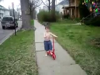 Reese snapping fingers and riding scooter