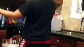 Brother dancing while doing the dishes.