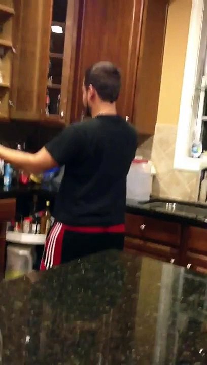 Brother dancing while doing the dishes.