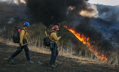 Thousands Flee Fast-Moving California Wildfires
