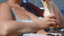 Stock Footage - Woman With Cocktail Sunbathing On Beach | VideoHive