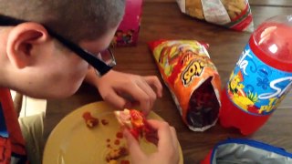 Jacob tries hot sauce with Cheetos on a weenie.
