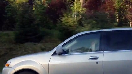 Woman Curls Her Hair While Driving Her Car