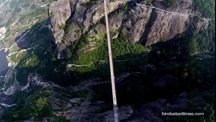 China shows workers converting a wooden bridge into a transparent
