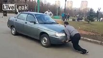 A strong guy stops a car by bare hands