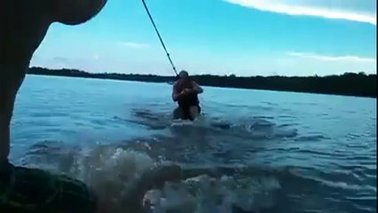 Man wake surfs without rope behind a boat... catches a beer
