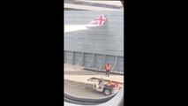 plane hits blast fence while pushing back from gate at JFK