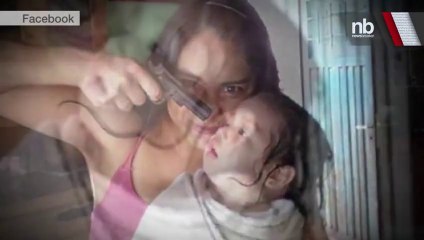 TERRIFYING- Photo of Woman Holding Gun at Baby