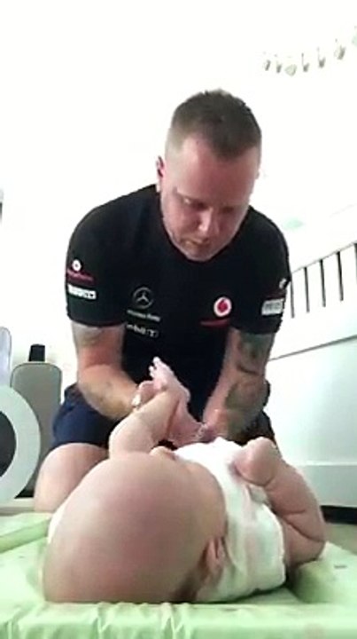 Ce papa a beaucoup de mal à changer son bébé