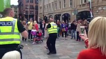 Des policiers dansent avec des passantes dans la rue à Glasgow