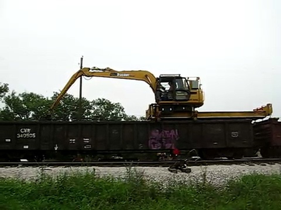 Union Pacific MOW equipment OTM Tracker machine unloading fresh ties