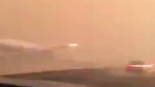 malaysia airline  plane on the other side of road during sand storm