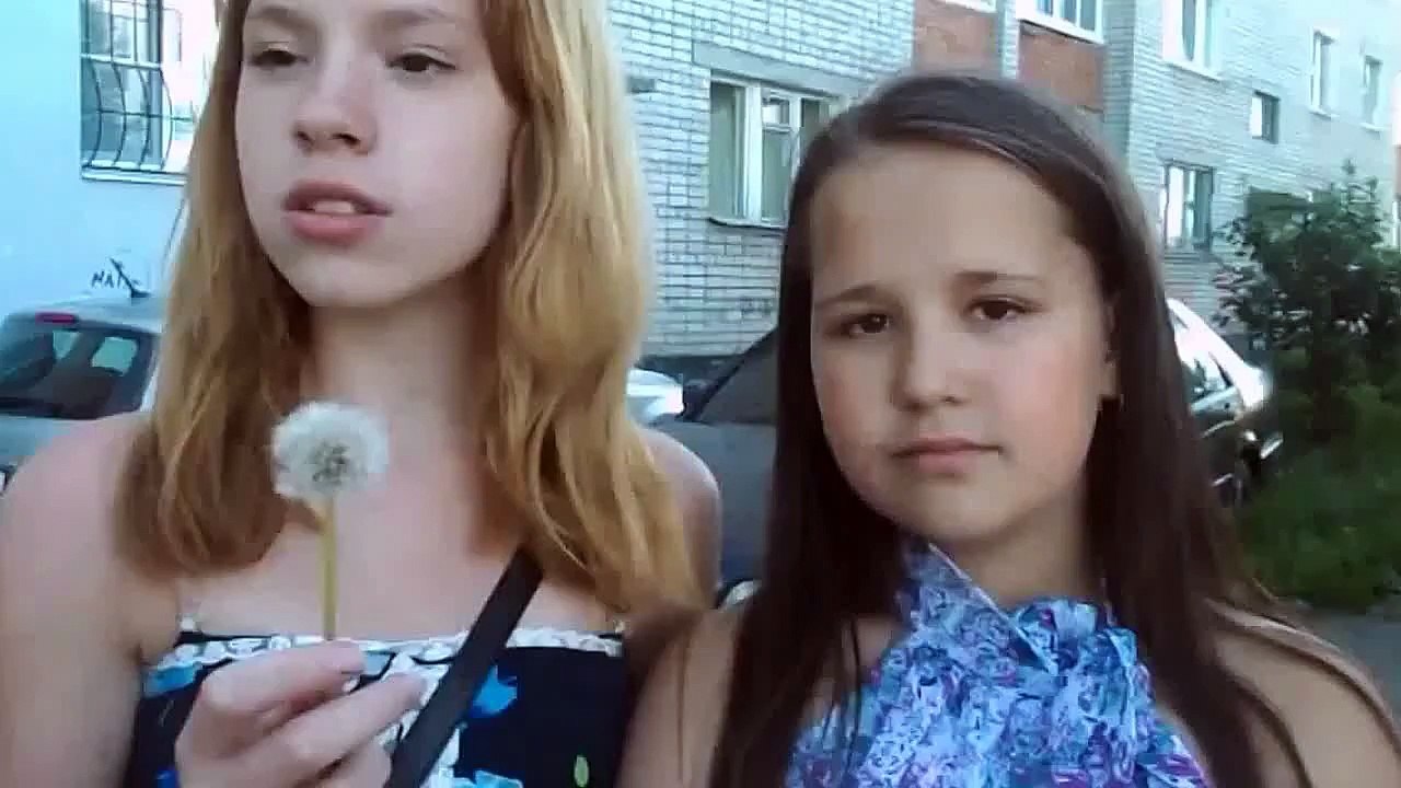 Girls Are Blowing On A Dandelion