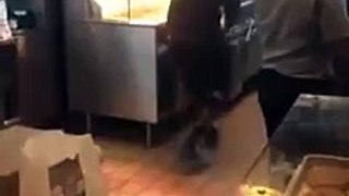 A pissed off black guy walks his way inside the McDonalds kitchen
