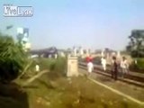 A grainy view of a Bangladeshi fellow finding a train on the track