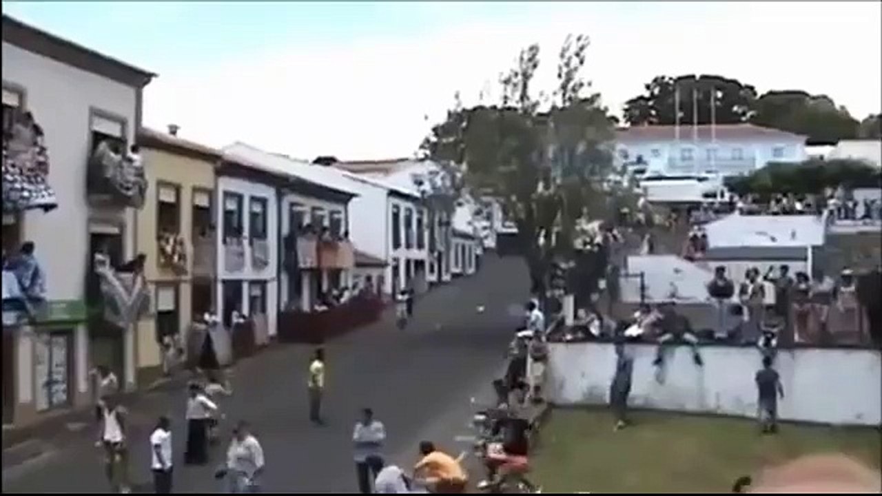 Guy busy taking video of audience gets hit by bull