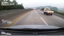 LiveLeak.com - Car loses it on expressway, crashes into barrier and something explodes