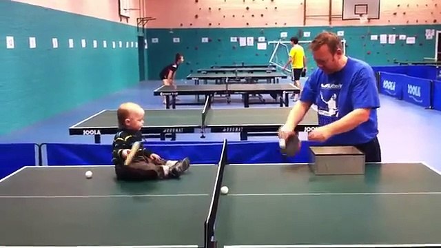 Un bébé joue au ping-pong