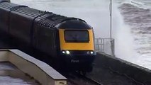 Huge water waves crashing over the train , train crashe by huge water waves