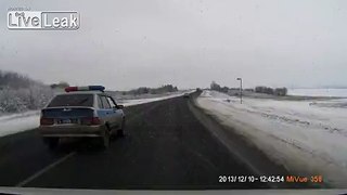 Police Car Slides into Ditch .... After Nearly Causing Head on Collision