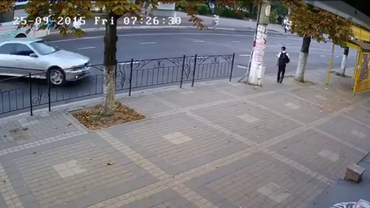RAW: School Boy Escapes After Car Crashes Into Pole On Sidewalk Moments After He Walks Away