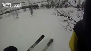 Skier falls into a hole