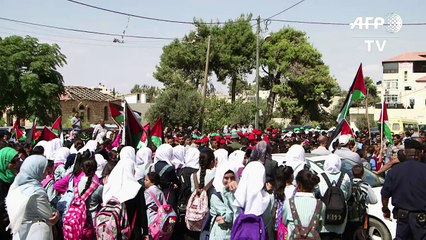 Palestinians celebrate the raising of their flag at the UN