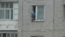 Baby playing by the window at the 8th floor... So scary moment and crazy russian kid!