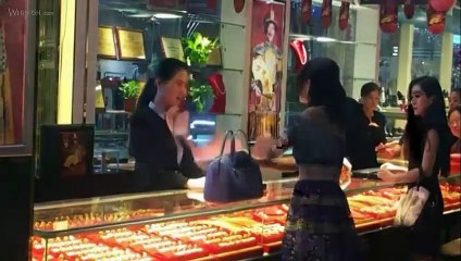 A rich lady customer throws wads of cash into sales girl's face