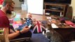 Baby cracks up at cat playing with tape measure
