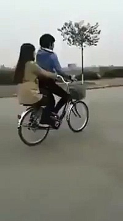 boy and girl are doing wheeling on cycle