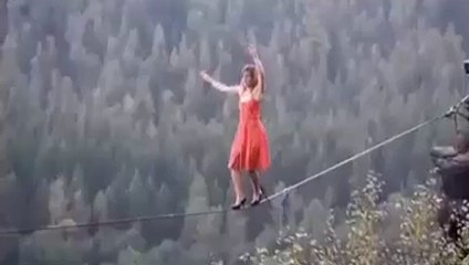a girl is walking on a rope it is amazing scene