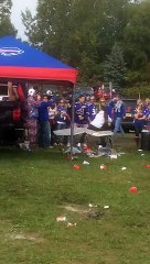 Football fan jumps over a table an goes KO on the ground while having Party with Buffalo Bill s Fans