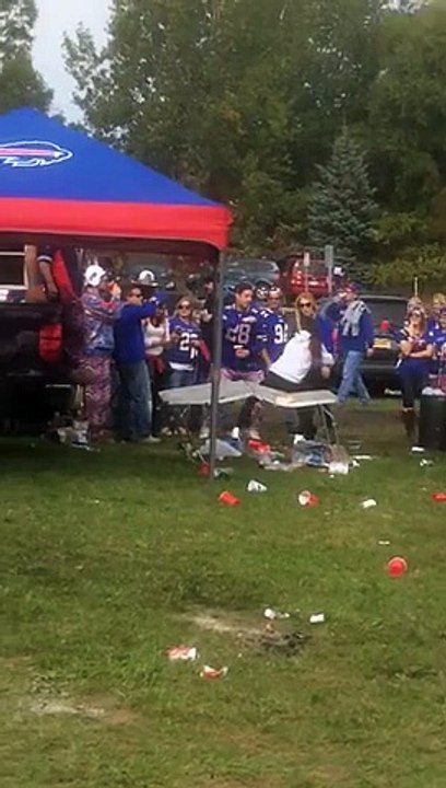 Football fan jumps over a table an goes KO on the ground while having Party with Buffalo Bill s Fans