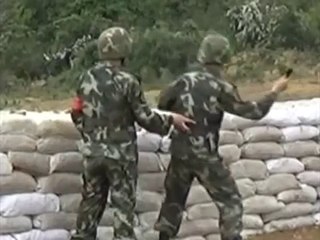 A soldier misses his throw grenade and is saved by his instructor