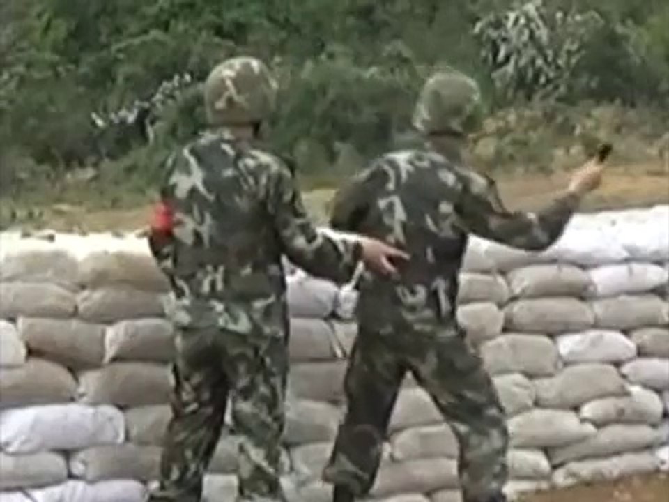 A soldier misses his throw grenade and is saved by his instructor