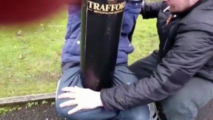 Man Tied to a Lamp Post With His Own Legs