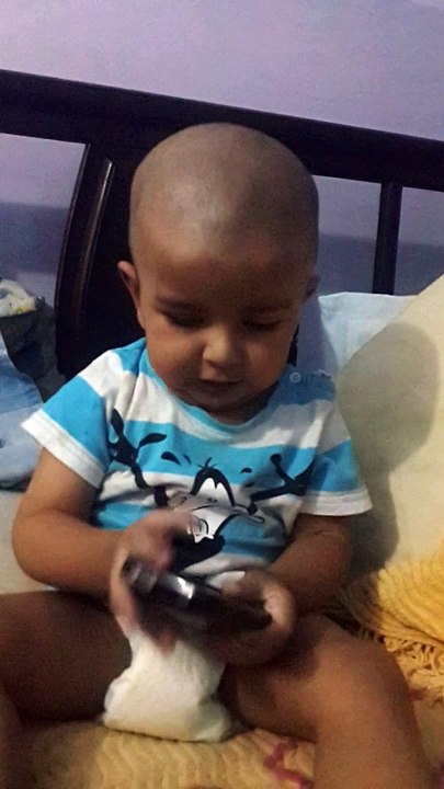 13 months toddler talking with his grandma on smartphone