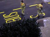 Workers paint letters on the street