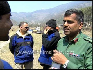 Porters carry loads into helicopter for trekkers - Everest expedition