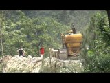 Bull-dozer repairs road, truck falls into gorge and creates Himalayan traffic jam