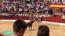 Dude jumps over barrier while running from bull, bull follows