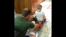 Dad pushes boy on scooter, puppy pulls him back!