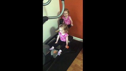 Twin girls take over elliptical machine
